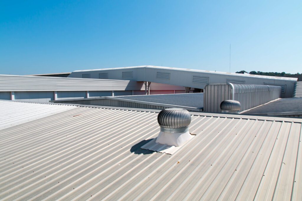 A flat roof on a business building with vents coming out