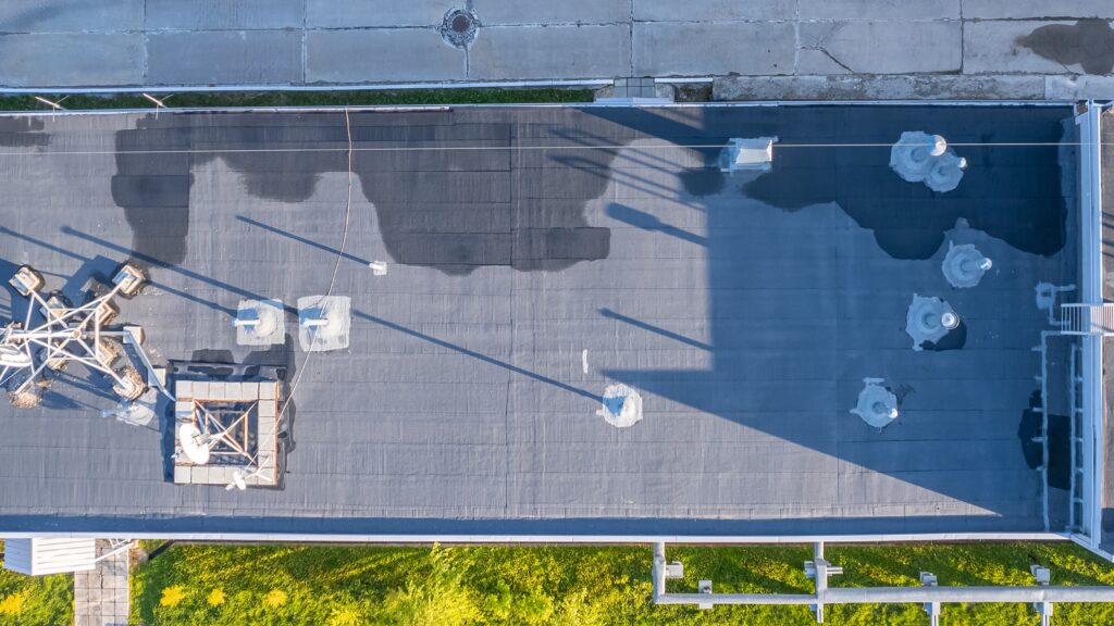 A commercial roof as viewed from above, with a leak