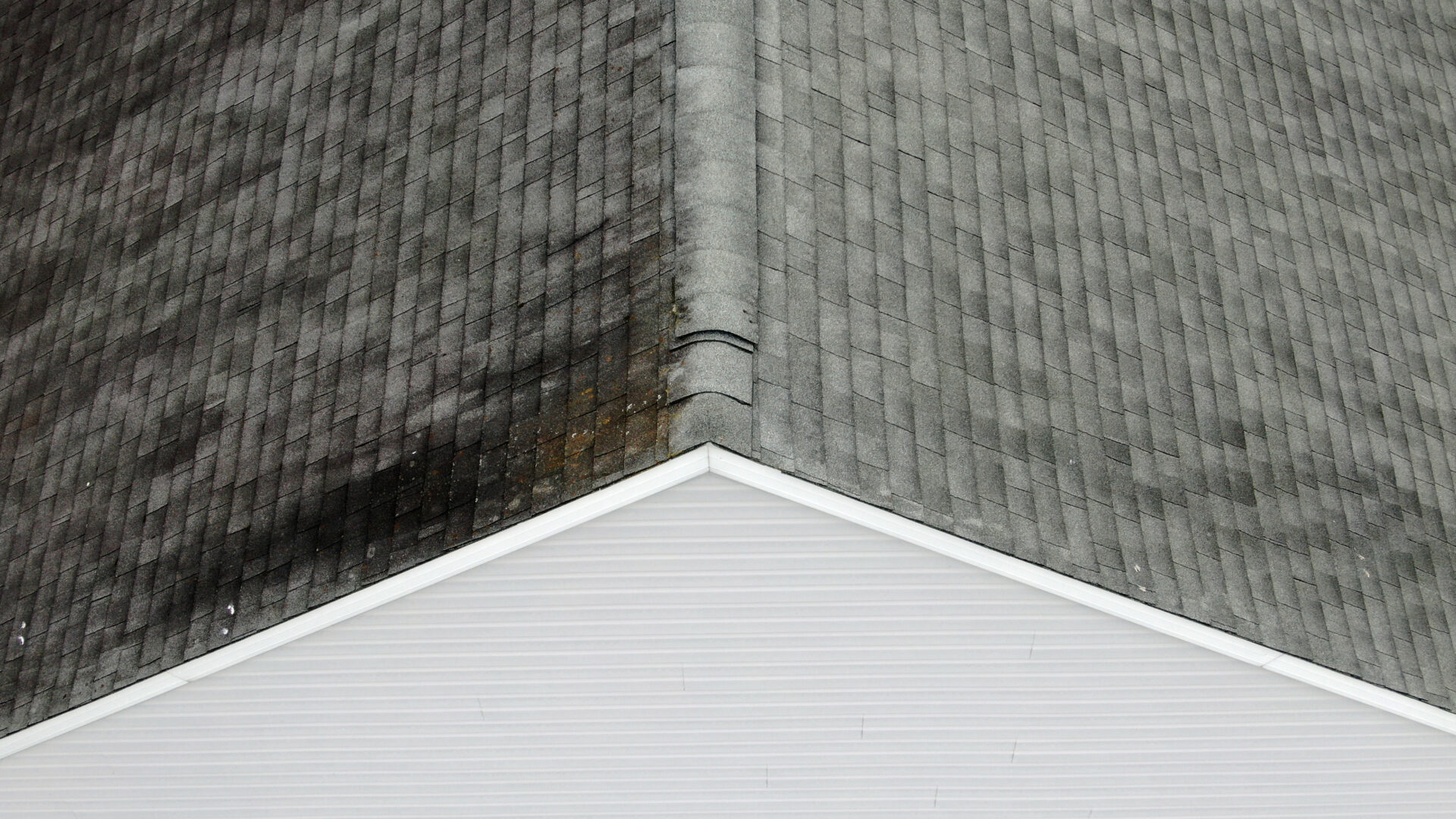 A home with a gray roof and leaking water