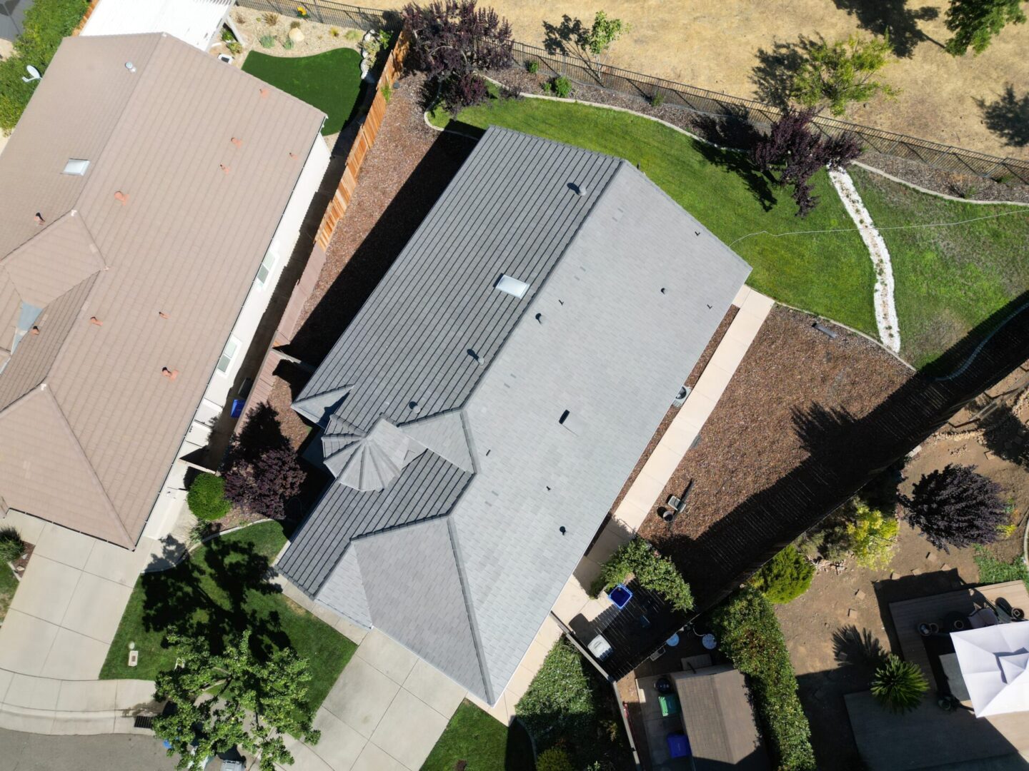 Aerial view of home with tile roofing and hills in the background