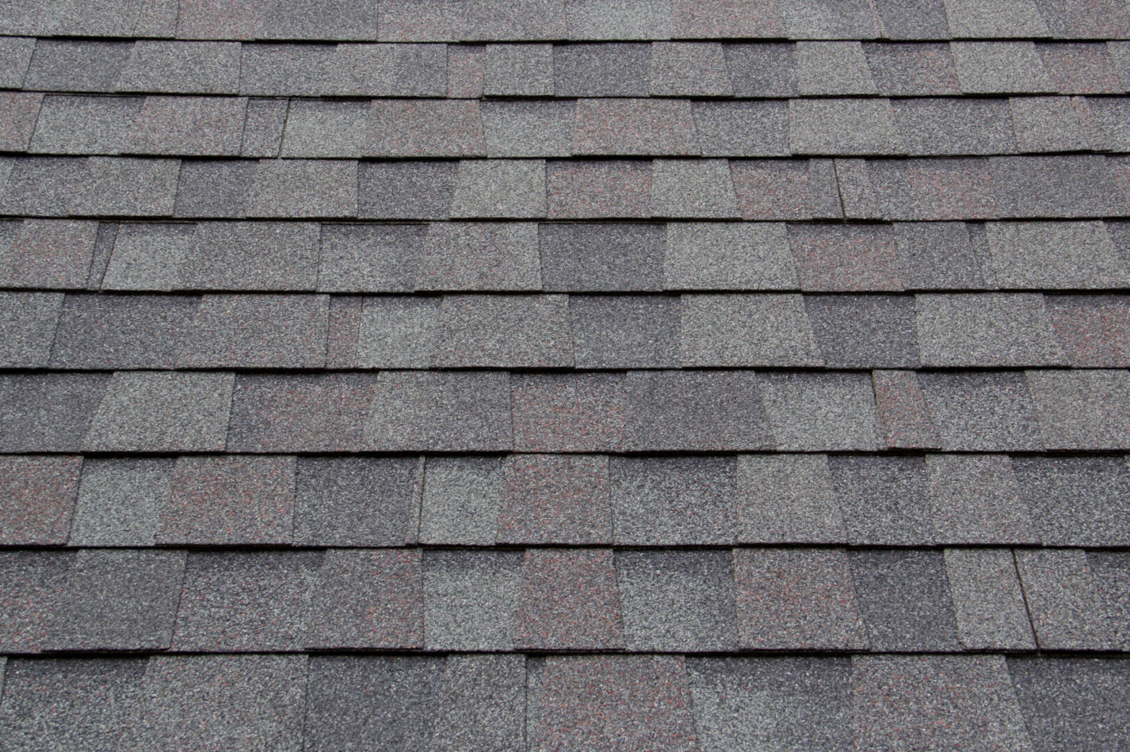 The recently repaired shingles on a business roof